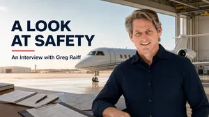 Greg Raiff in a private aviation hangar beside a business jet for an interview about safety.