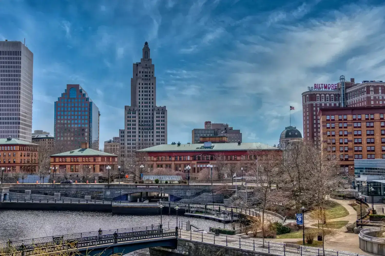 A panoramic view of the Providence, Rhode Island waterfront, showcasing the historic Industrial Trust Building and the Providence River.