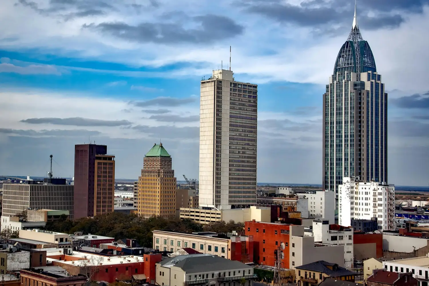 A stunning view of the Alabama skyline, showcasing a blend of historic charm and modern architecture, highlighted by the iconic RSA Battle House Tower.