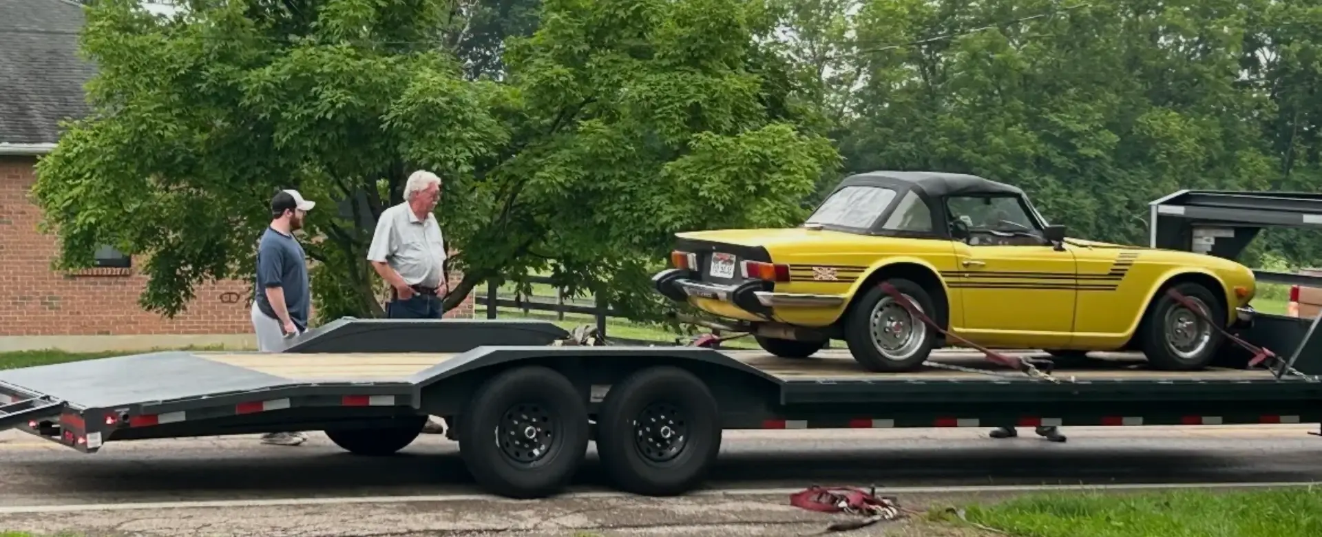 the Black SUV being Loaded onto Flatbed Trailer