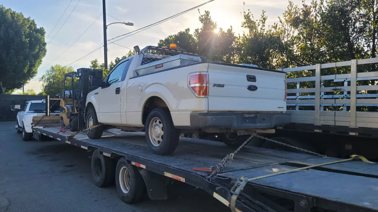 AutoStar Transport Express shipping a Ford F-150 pickup truck on a flatbed trailer.