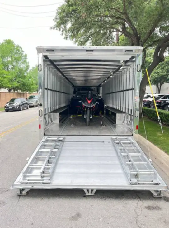 Motorcycles securely loaded in enclosed transport trailer for protected shipping from Illinois to Colorado