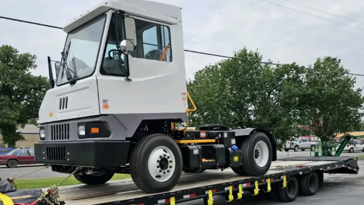 Terminal tractor truck transported on a flatbed trailer by AutoStar Transport Express