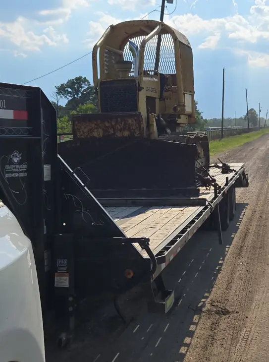 Bulldozer being transported on a trailer by AutoStar Transport Express.